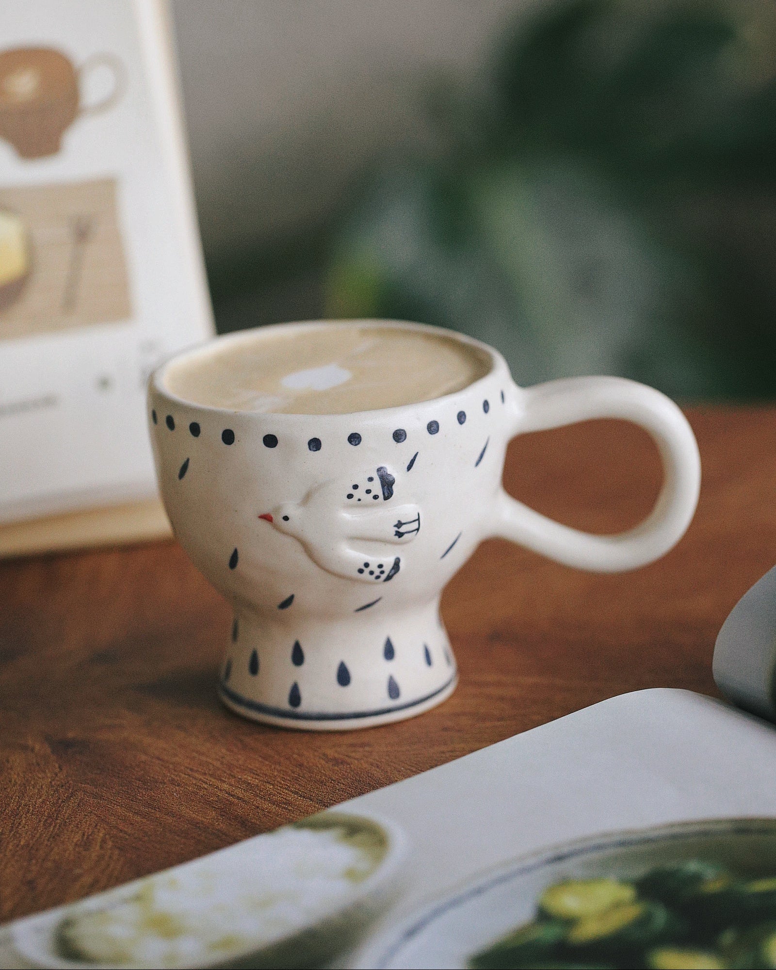 Ceramic mug with polka dot design on a wooden surface