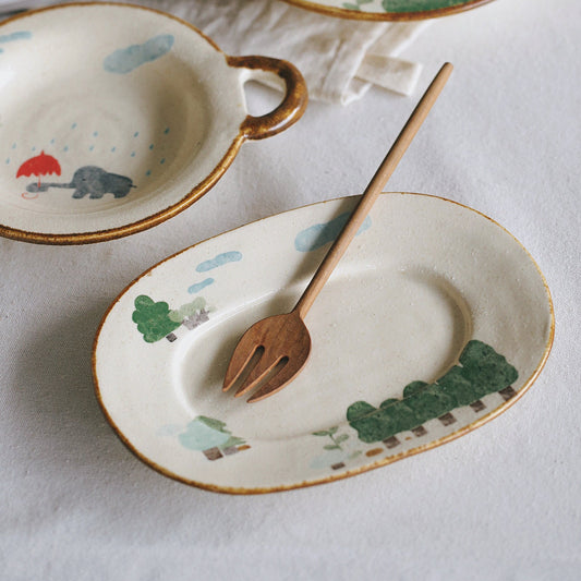 Ceramic tableware set with animal illustrations on a white surface