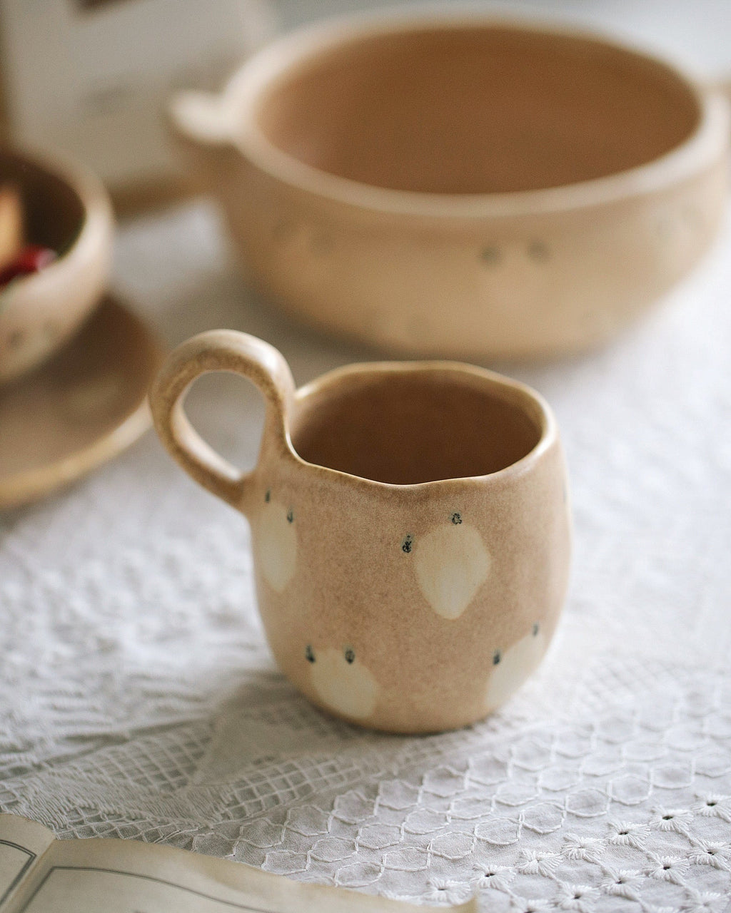 Ceramic mug with animal face design on a textured surface