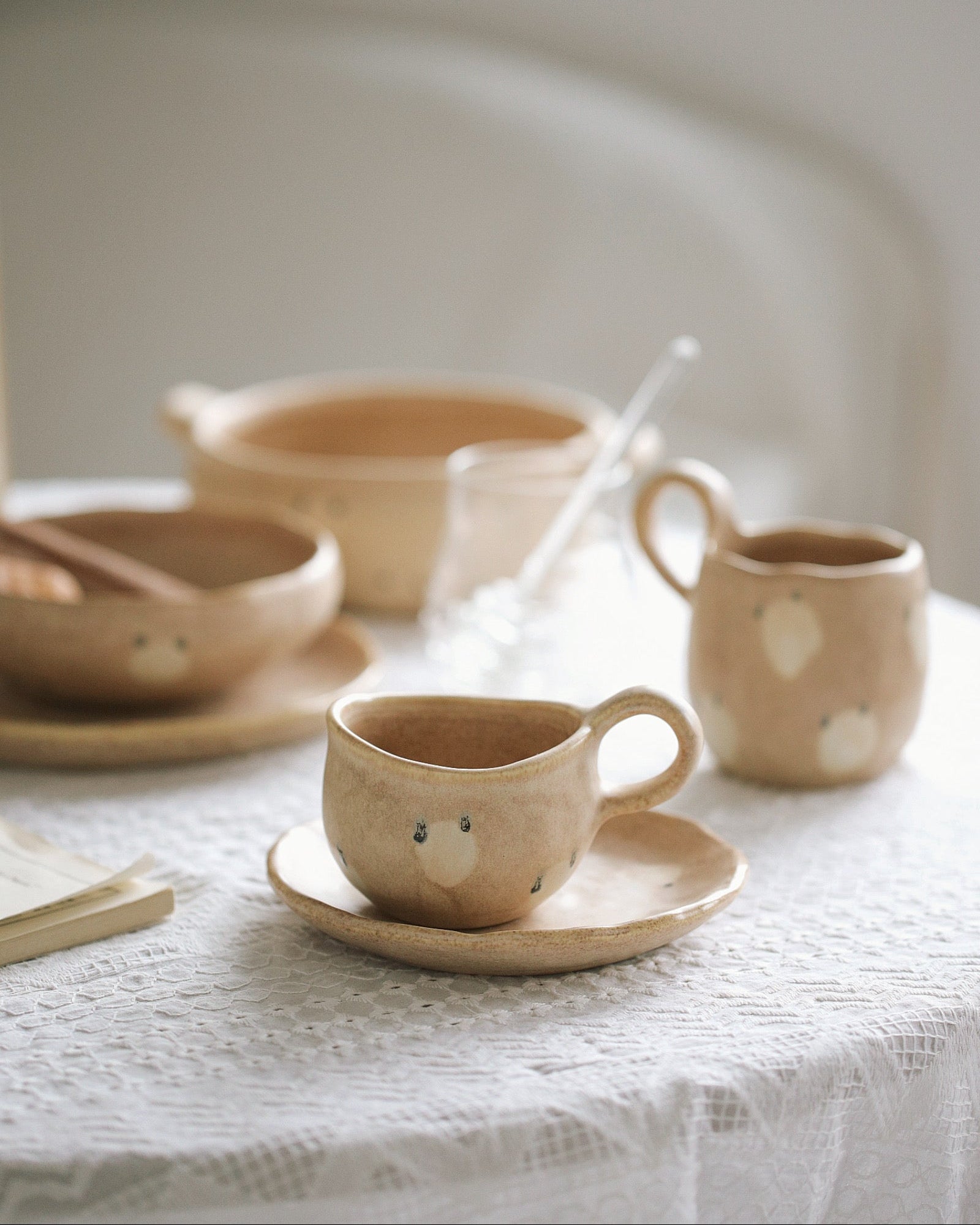 Ceramic tableware with animal face designs on a neutral background