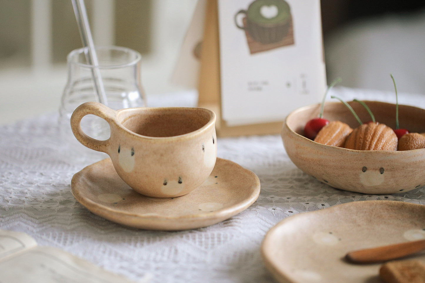 Set of ceramic tea cups and saucers on a table with a blurred background