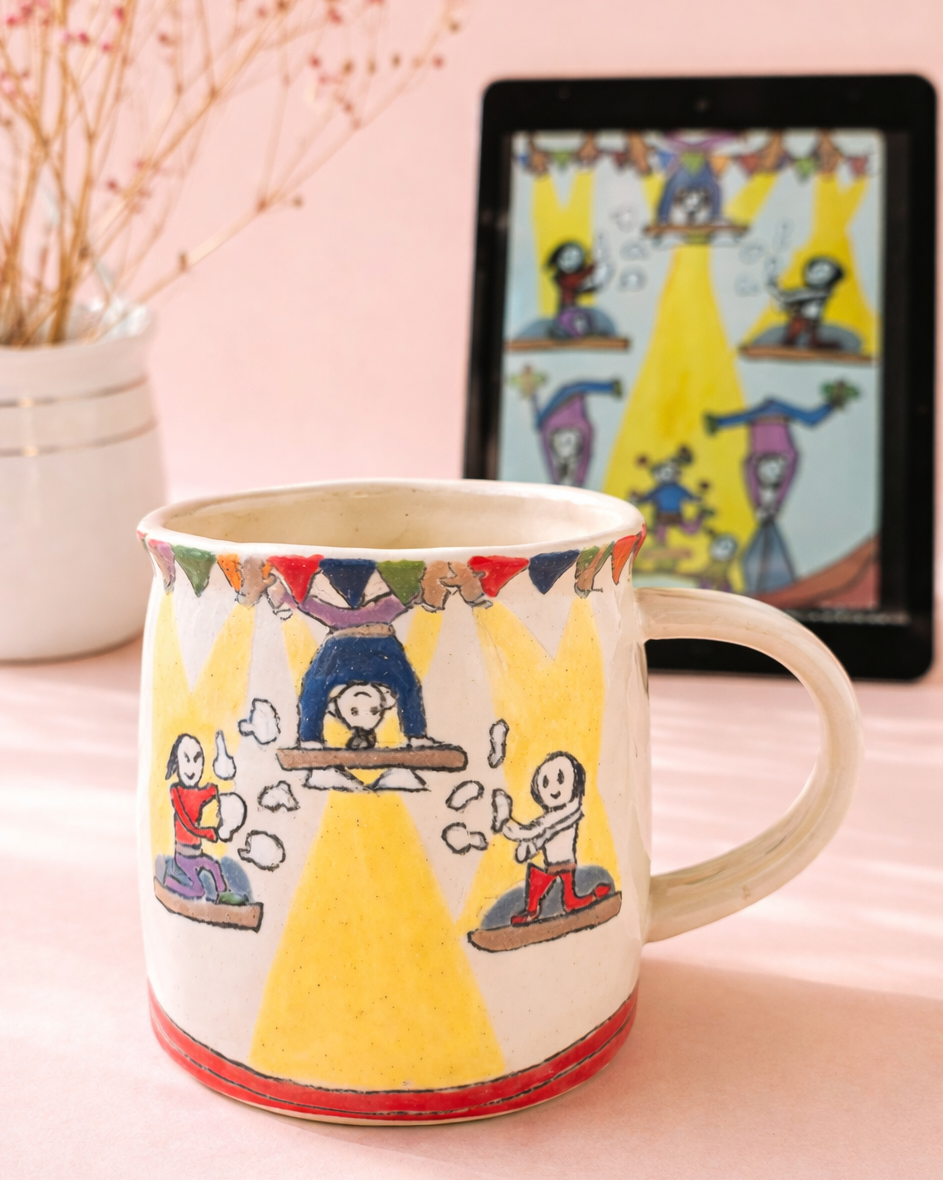 Colorful mug with illustrations on a pink surface, tablet displaying similar design in the background.